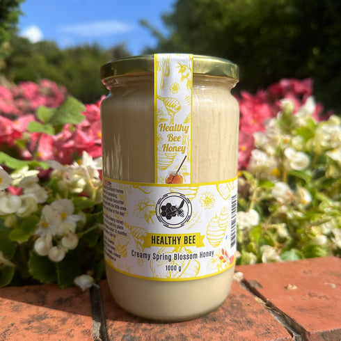 Jar of 'Healthy Bee' honey with a floral background