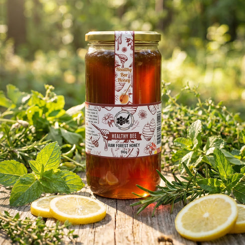 Jar of honey with a label on a wooden surface surrounded by greenery and lemons | Healthy Bee Ireland