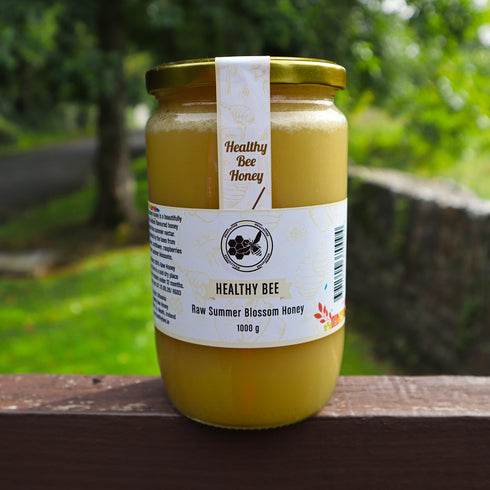 Jar of Healthy Bee Honey on a wooden surface with a natural background